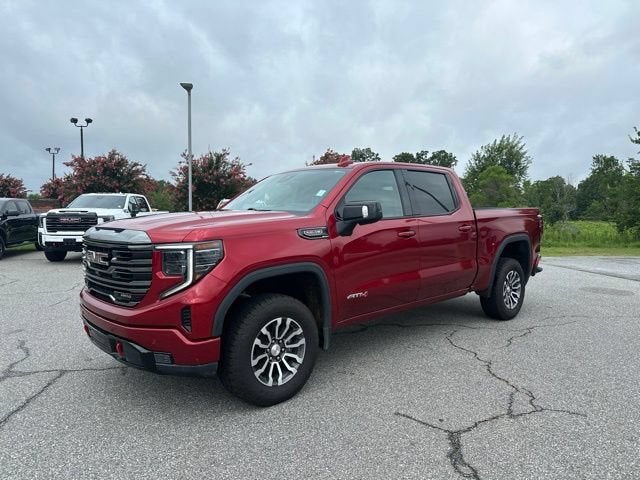 2023 GMC Sierra 1500 AT4 in Volcanic Red Tintcoat — front three-quarter view