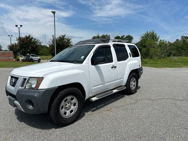 2012 Nissan Xterra X in White — front three-quarter view