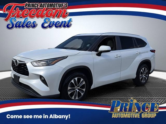 2023 Toyota Highlander L in White — front three-quarter view